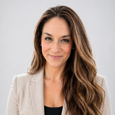 woman smiling in tan blazer