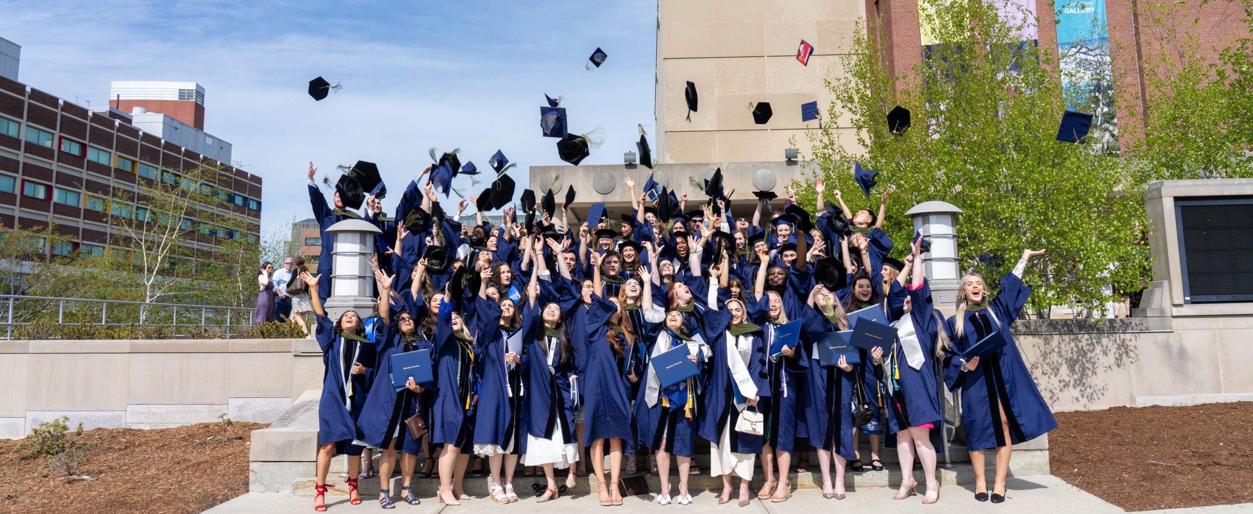 students tossing their caps at graduation