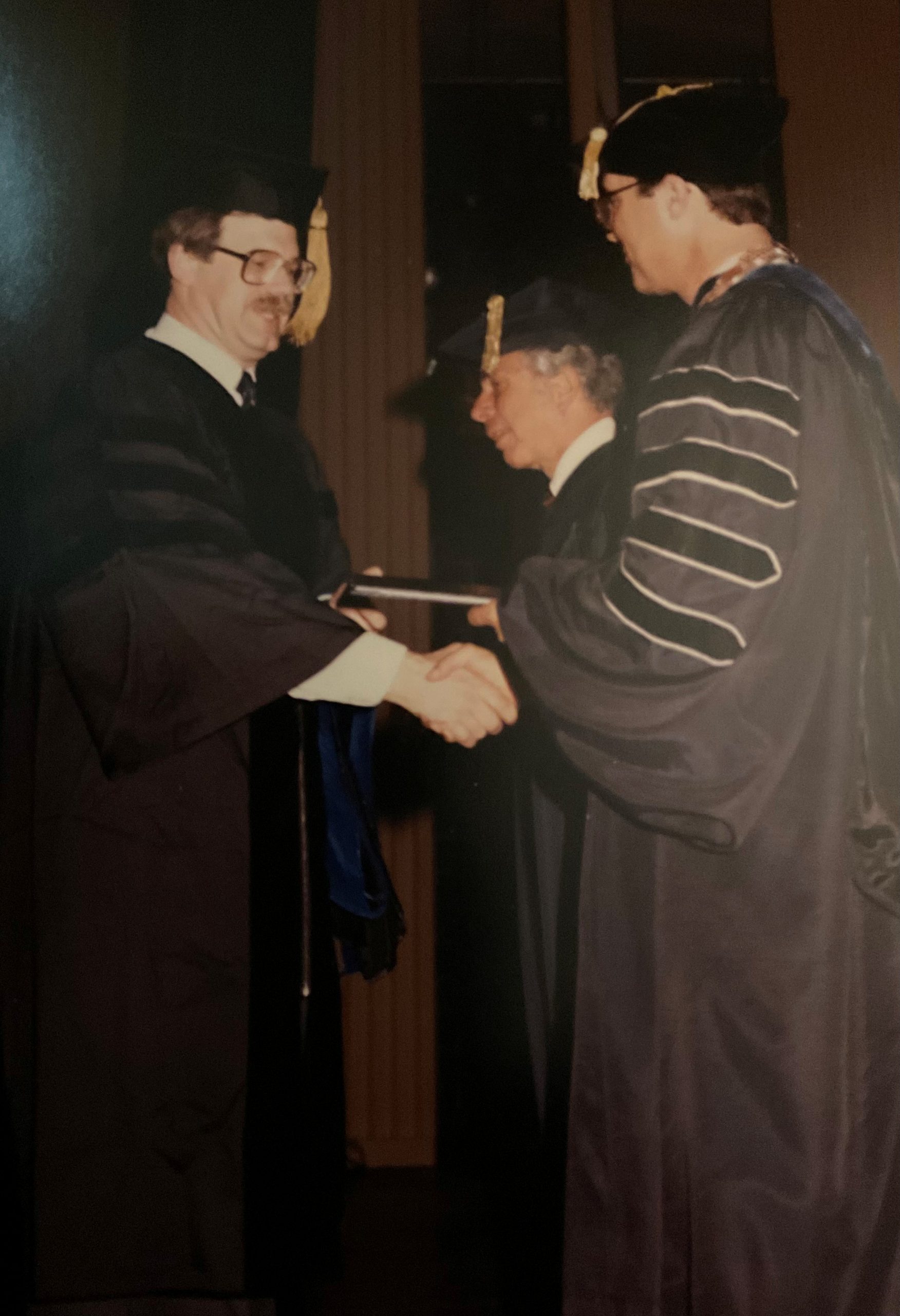 student graduating and shaking hands with the dean