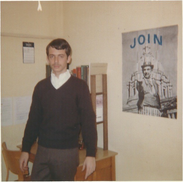 man standing in dorm room